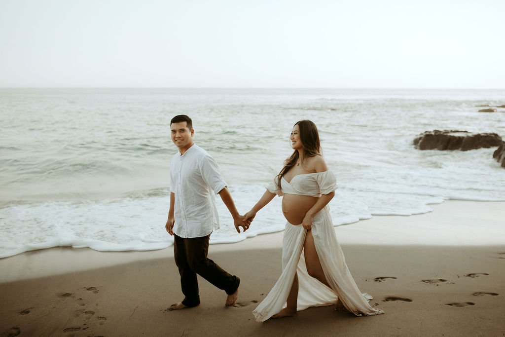 walking along the beach maternity session
